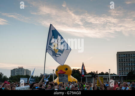 Belgrade, Serbia. 25th June, 2016. Demonstrators in front of Palace of Serbia in Belgrade. In background is huge yellow duck, symbol of the movement. Milos Bojovic/Alamy Live News Stock Photo