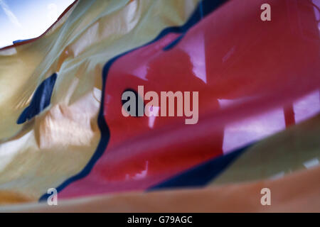 Belgrade, Serbia. 25th June, 2016. Speaker at demonstrations in front of Palace fo Serbia. He is photographed through the yellow duck flag. Milos Bojovic/Alamy Live News Stock Photo