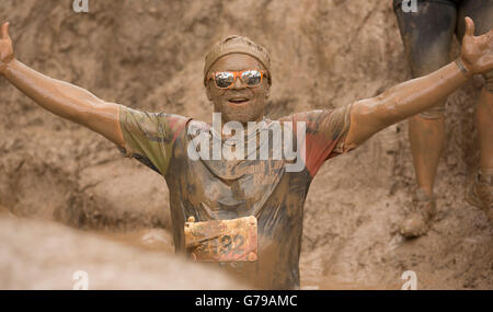 Man mud glorious mud on the Mud Mile obstacle at Tough Mudder at Drumlanrig Castle, Dumfries and Galloway, Scotland, UK. Stock Photo