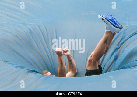 Pole vault athlete falls onto the crash mat during Stock Photo