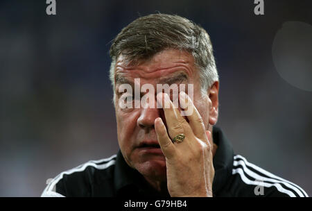 Soccer - 2014 Schalke 04 Cup - Schalke 04 v West Ham United - Veltins-Arena. West Ham United's manager Sam Allardyce rubs his eye as he waits to be interviewed following their victory in a penalty shoot out Stock Photo