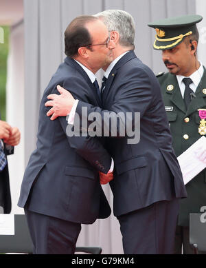 German Prime Minister Joachim Gauck embraces French President Francois Hollande during a ceremony at the Cointe Inter-allied Memorial, Liege, Belgium, commemorating the 100th anniversary of the start of the First World War. Stock Photo