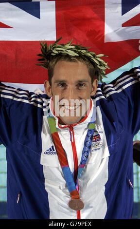 British swimmer Stephen Parry celebrates after winning a Bronze Medal in the Men's 200m Butterfly at the Olympic Aquatic Centre in Athens, Greece. 18/08/2004 Britain's Olympians will begin the fifth day, Wednesday August 18, 2004 at the Games with a massive boost after Parry won Team GB's second medal. Parry dedicated his Olympic bronze to his father - and lifted the gloom cast over the Games for Team GB, after his victory in the pool last night. His medal in the 200m butterfly secured Britain's first Olympic swimming medal for eight years and gave the country its second medal in Athens. Stock Photo