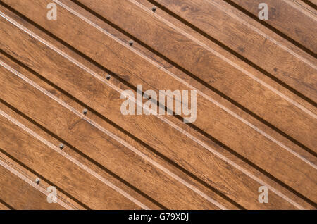 Brown siding that mimics the natural wood, for use as a background Stock Photo