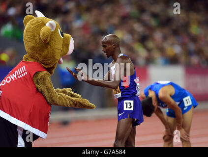 Great Britain's Mo Farah is congratulated by the Mascot Cooly after winning the Men's 10000m Final during day two of the 2014 European Athletics Championships at the Letzigrund Stadium, Zurich. Stock Photo