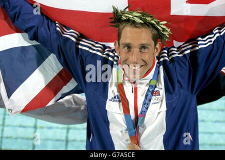 British swimmer Stephen Parry celebrates after winning a Bronze Medal in the Men's 200m Butterfly at the Olympic Aquatic Centre in Athens, Greece. Stock Photo