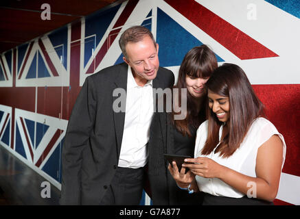 Skills Minister Nick Boles with apprentices Deepa Laxman (right) and Amber Askew during the launch of the Apprenticeships Get In, Go Far campaign at Google offices in London. Stock Photo