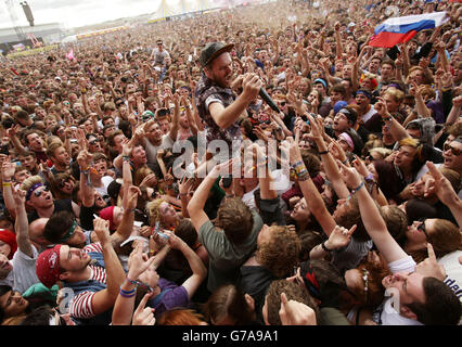 Roughton Reynolds of Enter Shikari dives into the crowd during their performance on the Main Stage, at the Reading Festival, at Little John's Farm on Richfield Avenue, Reading. Stock Photo