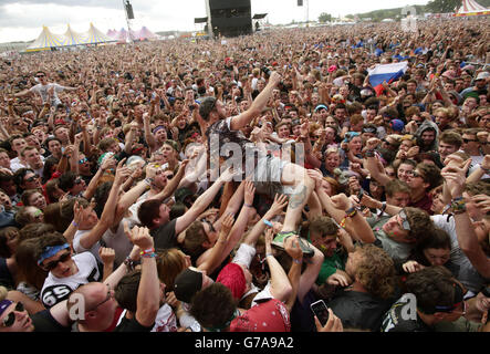 Roughton Reynolds of Enter Shikari dives into the crowd during their performance on the Main Stage, at the Reading Festival, at Little John's Farm on Richfield Avenue, Reading. Stock Photo