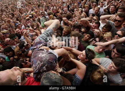 Roughton Reynolds of Enter Shikari dives into the crowd during their performance on the Main Stage, at the Reading Festival, at Little John's Farm on Richfield Avenue, Reading. Stock Photo