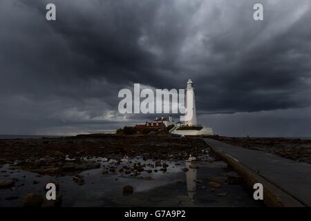 Previously unreleased image dated 22/08/14 of storm clouds gathering over St. Mary's lighthouse in Whitley Bay as people with plans for their three-day weekend will have to make the most of the sunshine today before rain moves in tomorrow evening bringing what is set to be unpleasant weather on Bank Holiday Monday. Stock Photo