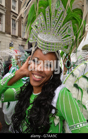 Participants get ready for the start of a rainswept Notting Hill Carnival in west London. Stock Photo