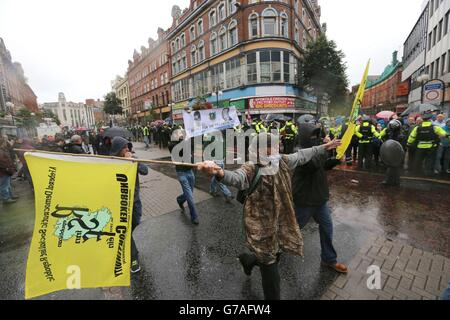 Police separate loyalist flag protesters from a republican parade in Belfast city centre, which has passed off largely peacefully. Stock Photo