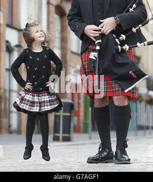Andrew Douglas from the Stuart highlanders Pipe Band and five-year-old Grace Carruthers launch the Piping Live! Glasgow International Piping Festival during a photocall in the city. Stock Photo