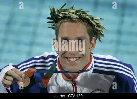 British swimmer Stephen Parry celebrates with his Bronze medal after coming third in the Men's 200m Butterfly at the Olympic Aquatic Centre in Athens, Greece. Stock Photo