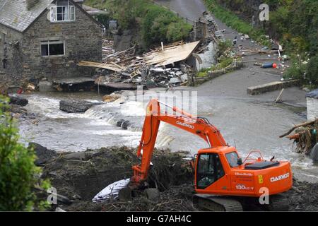 The clean up operation gets underway in Boscastle. Scores of villagers were airlifted to safety after a wall of water tore through the once picturesque north Cornwall village of Boscastle yesterday. Around five inches of rain fell in seven hours in the area and an estimated 3ft of water tore through the streets of the village, which lies in a deep valley leading to the sea. Stock Photo