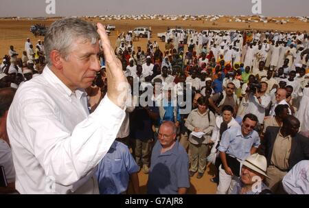 Foreign Secretary Jack Straw meets refugees in a feeding centre at the Abu Shouk camp near El Fasher in the northern Darfur region of Sudan. The camp - described by one British official as the 'Hilton' of the Darfur camps - is home to around 57,000 people forced to flee their villages following a campaign of violence by the Arab militias known as the Janjaweed. Mr Straw warned the Sudanese government that it must do more to protect refugees fleeing the violence in Darfur after seeing for himself the conditions in which they are living. Stock Photo