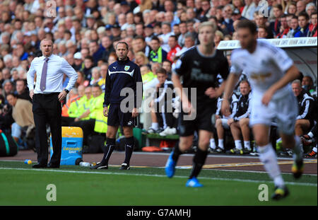 Burnley manager Sean Dyche (left) and assistant manager Ian Woam on the touchline during the Barclays Premier League match at the Liberty Stadium, Swansea. PRESS ASSOCIATION Photo. Picture date: Saturday August 23, 2014. See PA story SOCCER Swansea. Photo credit should read: Nick Potts/PA Wire. Stock Photo