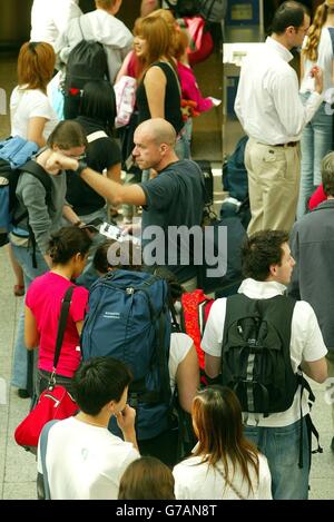 People queue up to check in on the eurostar at Waterloo Station, London, where there haven't been any delays due to srike action. Stock Photo