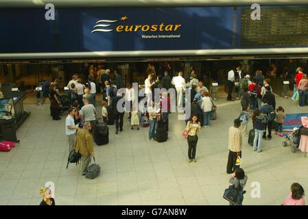 People queue up to check in on the eurostar at Waterloo Station, London, where there haven't been any delays due to srike action. Stock Photo