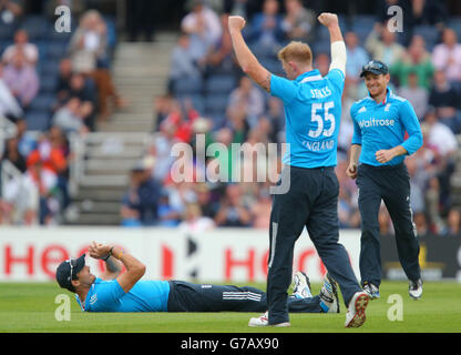 England's Ben Stokes celebrates taking the wicket of India's Ravichandran Ashwin after he was caught by England's Steven Finn, left, during the fifth ODI at Headingley Carnegie Stadium, Leeds. Stock Photo