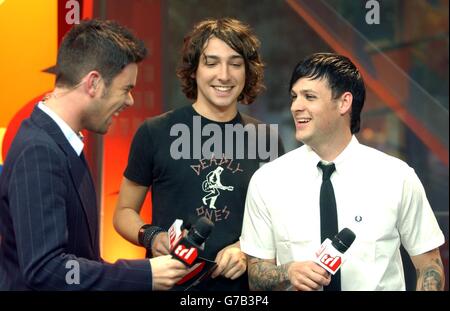 (L-R) MTV presenters Dave Berry and Alex Zane with Joel Madden from band Good Charlotte during their guest appearance on MTV's TRL - Total Request Live - show, at the new studios in Leicester Square, central London. Stock Photo