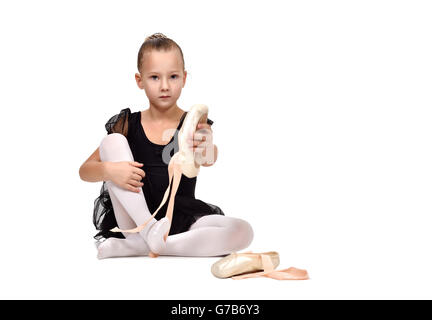 ballerina in black tutu wears ballet shoes Stock Photo
