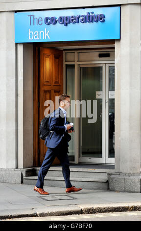 Stock photo of a man walking past a co-operative bank in Holborn, central London. Stock Photo