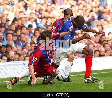 Portsmouth's Ricardo Fuller breaks past Crystal Palace's Danny Granville (L) and Joonas Kolkka (centre) during their Barclays Premiership match at Fratton Park, Portsmouth, Saturday, September 11, 2004. Stock Photo