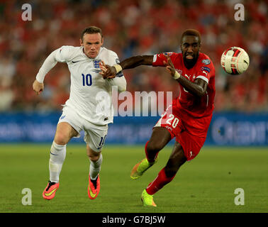 England's Wayne Rooney (left) and Switzerland's Johan Djourou battle for the ball during a UEFA Euro 2016 qualifying, Group E match at the St Jakob-Park Stadium, Basel. Stock Photo