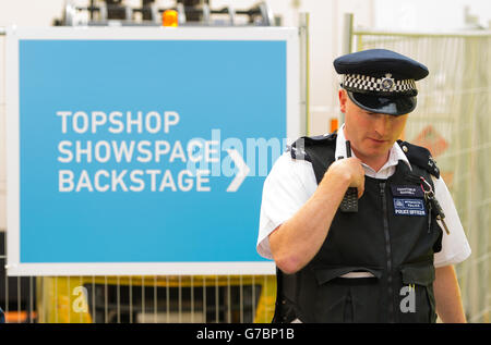 A policeman outside the Topshop Show Space in central London, after a man was injured falling through the roof of the venue during the Fashion East catwalk show, during London Fashion Week. Stock Photo