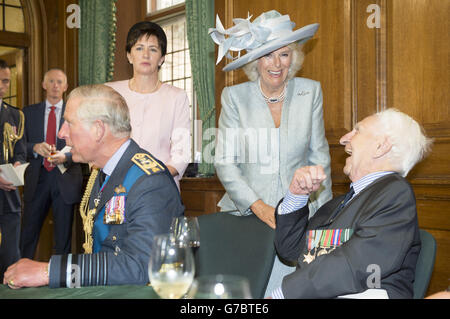 The Prince of Wales and the Duchess of Cornwall talk to veterans at a reception after they attended the Battle of Britain Fighter Association Service of Thanksgiving and Rededication at Westminster Abbey, London. Stock Photo