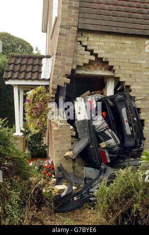 The scene after a family had a lucky escape when a car smashed into their home, coming to rest at the bottom of the stairs. Five people were upstairs when a white BMW careered into their home in Warlingham, Surrey, at 11pm yesterday. Surrey Police said the car smashed into a garden, skimmed the wall of one house, damaging a bay window, and then came crashing into the neighbouring home. Stock Photo