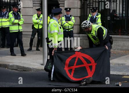 A protester is moved by members of the Garda as demonstrators gathered ...