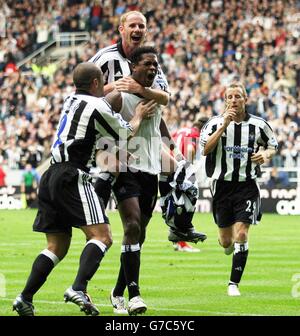 Newcastle Patrick Klluivert (centre) is ongratulated by team mates after scoring against West Brom during the Barclaycard Premiership match at St James' Park, Newcastle, Saturday September 25, 2004. Stock Photo