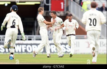 Lancashire's Simon Kerrigan celebrates taking the wicket of Middlesex batsman Sam Robson with Liam Livingstone (left), during day three of the LV= County Championship match at Old Trafford, Manchester. Stock Photo