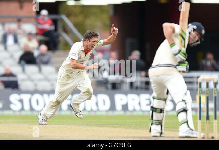 Lancashire's Simon Kerrigan (left) celebrates taking the wicket of Middlesex batsman Joe Denly (right), during day three of the LV= County Championship match at Old Trafford, Manchester. Stock Photo