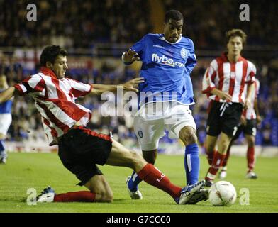 Birmingham City's Julian Gray (right) is tackled by Lincoln City's Richard Butcher during their Carling Cup second round match at St Andrews, Birmingham. Stock Photo