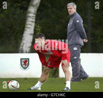 Wales' captain Gary Speed warms up under the watchfull eye of Manager Mark Hughes (right) before playing England in World Cup Qualifier at Old Trafford, Manchester. Stock Photo