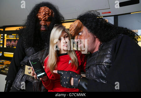 Tanya Harding shows Star Trek fans, who are dressed as Klingons, Microsoft's Cortana, the built-in personal digital assistant included in Microsoft Windows Phone 8.1 Update, on the newly released Nokia Lumia 830 smartphone, during the Destination Star Trek event at ExCeL London. Stock Photo