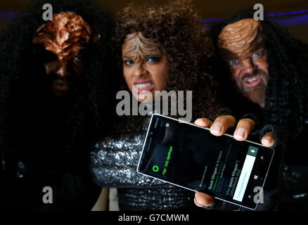 A Star Trek fans dressed as a Klingon demonstrates Microsoft's Cortana, the built in personal digital assistant included in Microsoft Windows Phone 8.1 Update, on the newly released Nokia Lumia 830 smartphone, during the Destination Star Trek event at ExCeL London. Stock Photo
