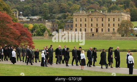 The Prince of Wales and the Duchess of Cornwall walk past Chatsworth house towards St Peter's Church for the funeral of Deborah, the Dowager Duchess of Devonshire. Stock Photo