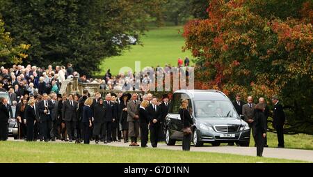 Mourners including the Prince of Wales and the Duchess of Cornwall follow the hearse for the funeral of Deborah, the Dowager Duchess of Devonshire at St Peter's Church. Stock Photo