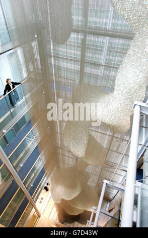 Artist Thomas Heatherwick unveils his new seven-storey sculpture, commissioned by the Wellcome Trust, at their new headquarters in Euston Road, central London. Constructed with 150,000 glass spheres, and suspended on almost one million metres of fine stainless steel wire, the work illuminates the surrounding space with constantly shifting colour and light in a spectacular 30 metre-high void. The form of the sculpture has been derived from the twisted shape of a drop of molten metal, cooled and solidified as it fell through tumbling water. Stock Photo