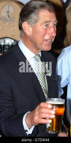 The Prince of Wales, holds a pint of Summer Lightning real ale from England's Hop Back brewery at the Lingotto complex in Turin, Italy, during a visit to the 'Salone Del Gusto' food festival. Stock Photo