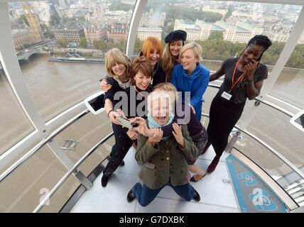 (from left) Rachel Johnson, Kathy Lette, Mary Portas, Julie Walters, Cathy Newman, Natascha McElhone, Stella Creasy MP and Christine Ohuruogo pose for a selfie as they mentors girls from Dunraven School in Streatham on the London Eye as part of Southbank Centre's activities to mark the third UN International Day of the Girl, London. Stock Photo