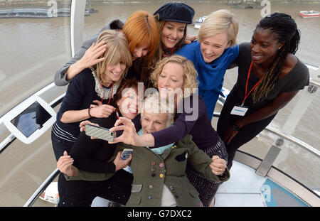 (from left) Rachel Johnson, Kathy Lette, Mary Portas, Julie Walters, Cathy Newman, Natascha McElhone, Stella Creasy MP and Christine Ohuruogo pose for a selfie as they mentors girls from Dunraven School in Streatham on the London Eye as part of Southbank Centre's activities to mark the third UN International Day of the Girl, London. Stock Photo