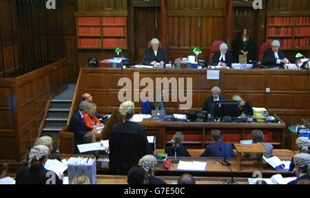 A still taken from a video feed of (left to right, back row) Mr Justice Turner, Lord Justice Treacy and Judge Michael Pert QC during the filming of Max Clifford's appeal hearing in the Court of Appeal, London, as the three Court of Appeal judges said they would give their decision in his case at a later date after they heard argument on his behalf against his 'too long' prison term. Stock Photo