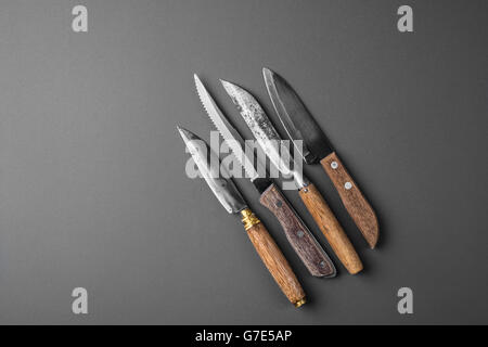 collection of various kitchen knives on a grey background Stock Photo
