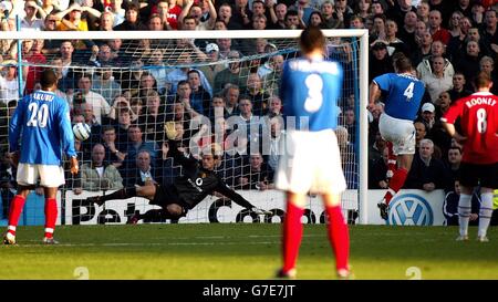 Goalkeeper Roy Carroll of Manchester United dives the wrong way as Portsmouth's David Unsworth scores a penalty during the Barclays Premiership match at Fratton Park, Portsmouth, Saturday October 30, 2004. Stock Photo